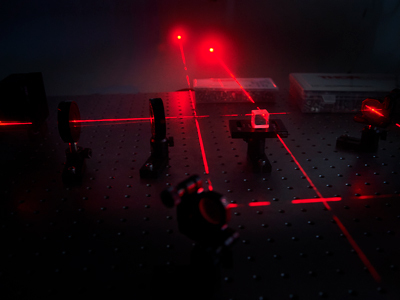 Three red lasers crossing over each other